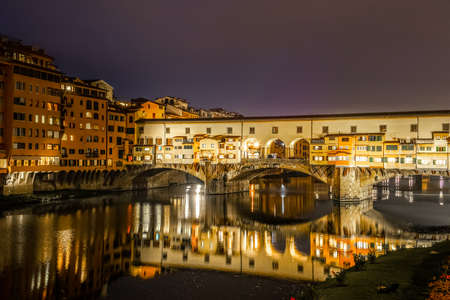 Ponte Vecchio over Arno river at night in Florence. Tuscany, Italyの写真素材