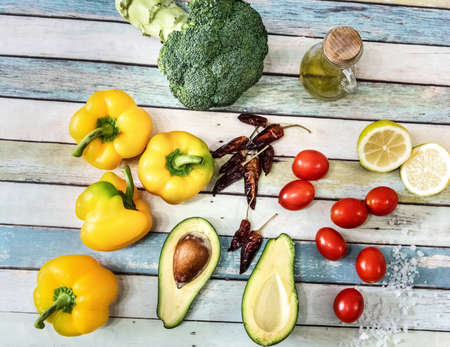 Colorful wholesome vegetables on a wooden table seen from aboveの写真素材