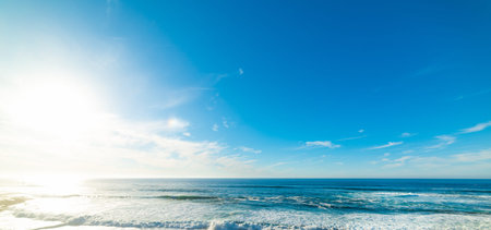 Small waves under a shining sun in La Jolla Beach at sunset. Southern California, USAの写真素材