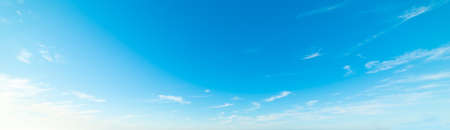 blue sky with white, soft cloudsの写真素材