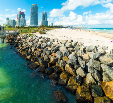 Breakwater and skyscrapers in Miami Beach southern shore, USAの写真素材