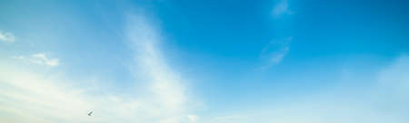 blue sky with white, soft cloudsの写真素材