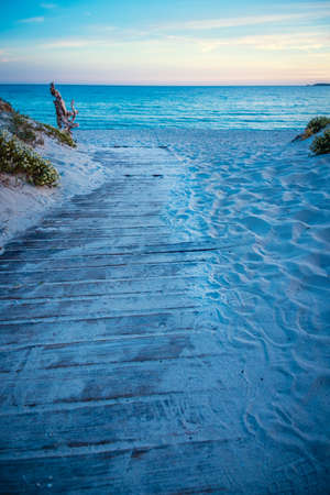 Wooden boardwalk in Maria Pia beach at sunset. Sardinia, Italyの写真素材