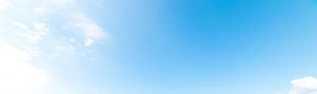 blue sky with white, soft cloudsの写真素材