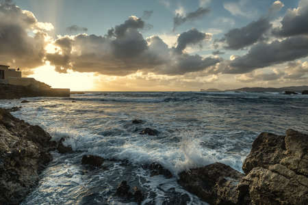 Rough sea and rocky shore in Alghero at sunset. Sardinia, Italyの写真素材