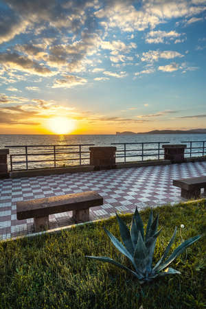 Alghero seafront under a cloudy sky at sunset. Sardinia, Italyの写真素材