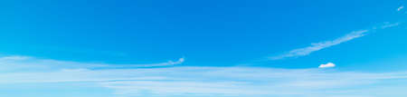 blue sky with white, soft cloudsの写真素材