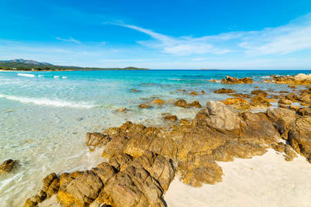 Rocks and sand in Rena Bianca beach in Sardinia, Italyの写真素材
