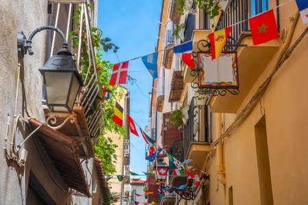 Flags in a narrow alley in old town Sorrento, Italyの写真素材