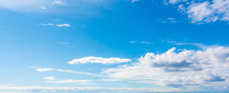 blue sky with white, soft cloudsの写真素材
