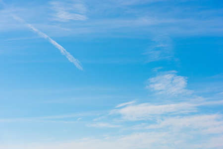 blue sky with white, soft cloudsの写真素材