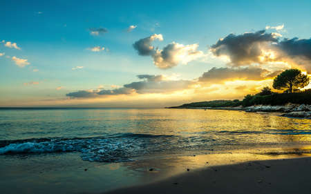 Cloudy sky over Fertilia shore at sunset. Sardinia, Italyの写真素材