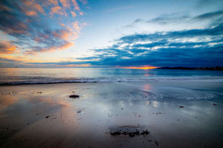 Dark clouds over the sea at sunset in Maria Pia beach in Alghero. Sardinia, Italyの写真素材