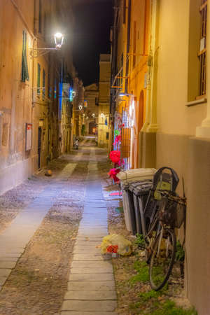 Narrow street in old town Alghero at night. Sardinia, Italyの写真素材
