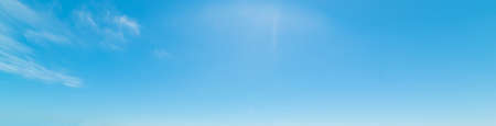 blue sky with white, soft cloudsの写真素材