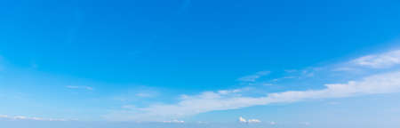 blue sky with white, soft cloudsの写真素材