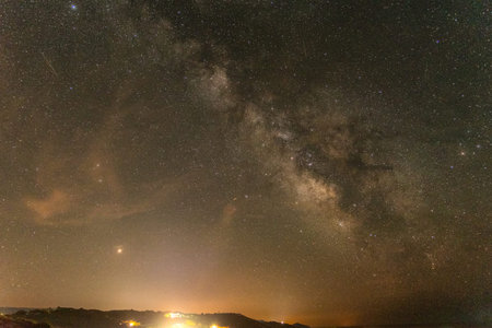Milky way over Alghero rocky coastline at night. Sardinia, Italy