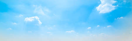 blue sky with white, soft cloudsの写真素材