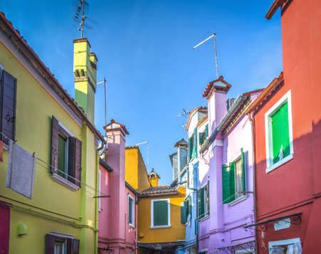 Colorful buildings in Burano under a blue sky, Italyの写真素材