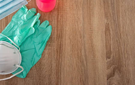 Protective masks, disposable gloves and alcohol bottle seen from aboveの写真素材