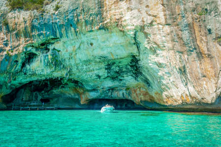 Motorboat by a rocky cliff in Orosei Gulf. Orosei gulf lies in the Sardinia east coast, Italyの写真素材