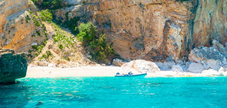 Rubber boat on beautiful Cala Mariolu water. Sardinia, Italyの写真素材