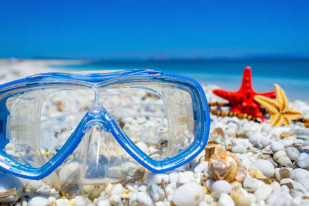 Scuba mask on white pebbles by the sea in summetimeの写真素材
