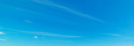 Small white clouds and blue sky in Sardinia in summerの写真素材