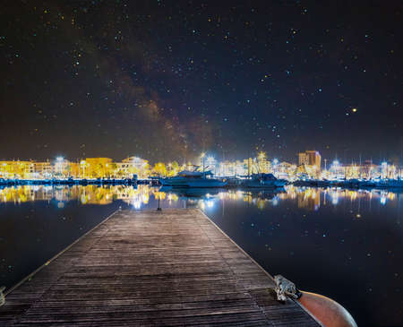 Starry sky over Alghero harbor at night. Sardinia, Italyの写真素材