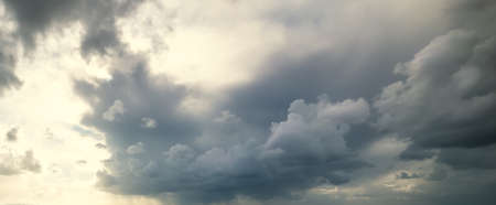 Dark clouds at sunset in winter in Italyの写真素材
