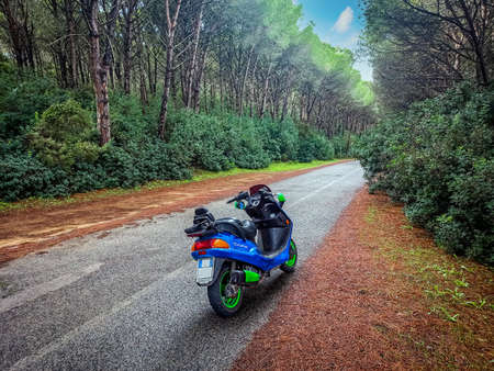 Colorful scooter parked on the edge of a country road in Sardinia, Italyの写真素材