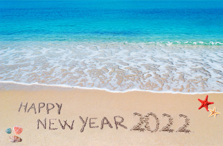 "happy new year 2022" written on a tropical beachの写真素材