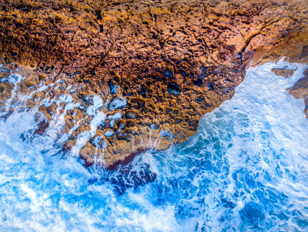 Rocky shore and rough sea seen from above. Sardinia, Italyの写真素材