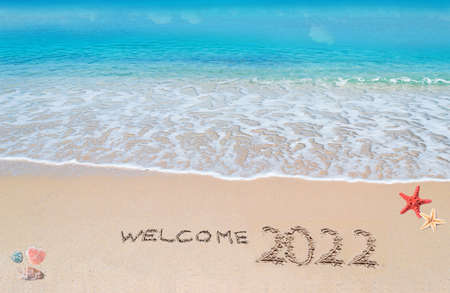 welcome 2022 written on the sand by the seaの写真素材