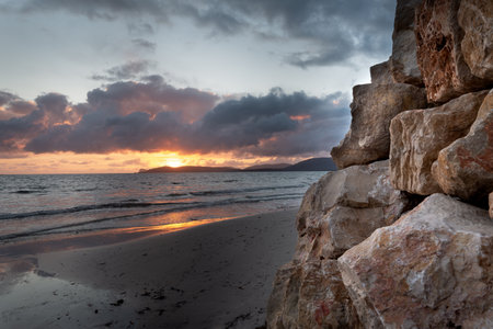 Rocks by the sea in Alghero at sunset. Sardinia, Italyの写真素材