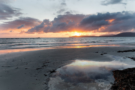 Puddle on the sand in Alghero at sunset. Sardinia, Italyの写真素材