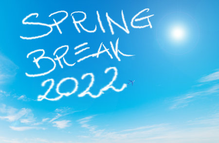 Spring break 2022 written by contrails in the blue skyの写真素材
