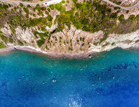 Aerial view of the blue sea by a rocky cliff in Sardinia, Italyの写真素材