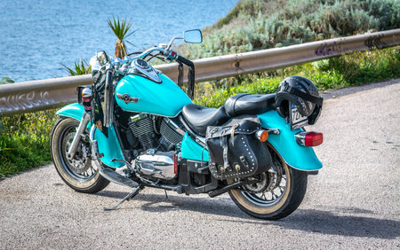 Sardinia, ITA - March 25, 2022: Turquoise Kawasaki VN 800 parked by the sea on a sunny dayのeditorial素材