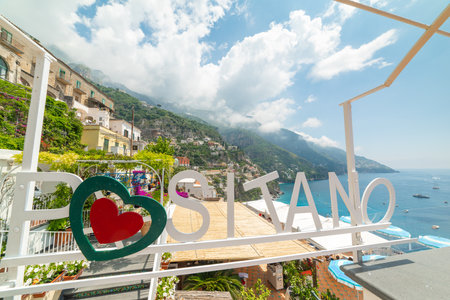 Positano, ITA - May 24, 2018: Positano sign with the shore on the backgroundのeditorial素材