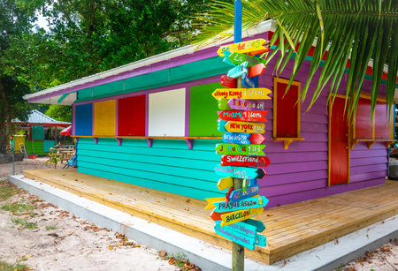 Wooden mileage signpost by a colorful beach bar in La Digue island, Seychellesの写真素材