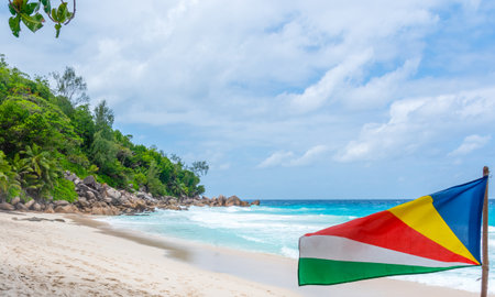 Seychelles flag by the sea in Anse Georgette. Praslin island, Seychellesの写真素材