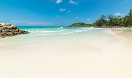White sand and turquoise water in Anse Kerlan beach. Praslin island, Seychellesの写真素材