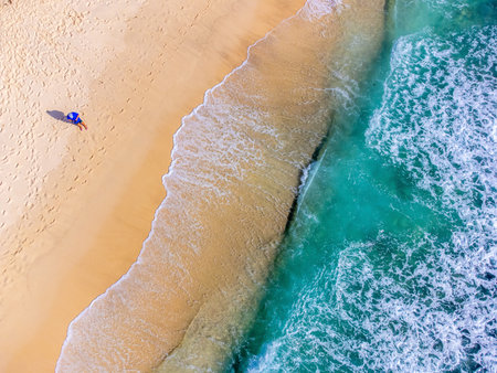 Aerial view of a man by the sea in Takamaka beach. Mahe island, Seychellesの写真素材