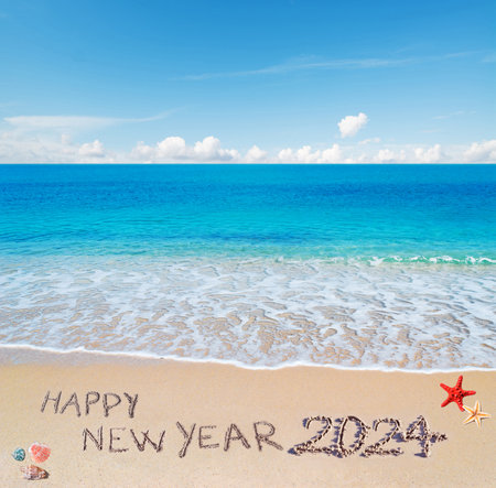 "happy new year 2024" written on a tropical beachの写真素材