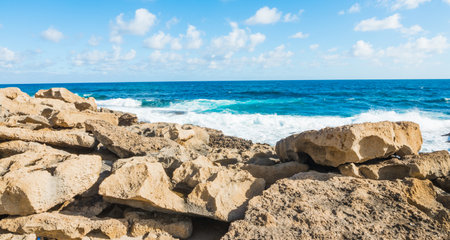 Yellow rocks by the shore in Sardinia, Italyの写真素材