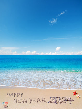 "happy new year 2024" written on a tropical beachの写真素材