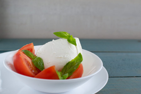Large juicy mozzarella and small pieces of fresh tomato, a few twigs or basil leaves - if you add...