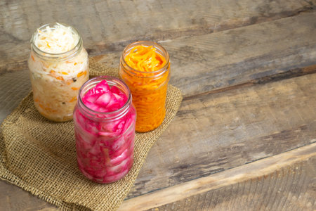 Pickled vegetables in glass jars cooked according to the classic recipe.