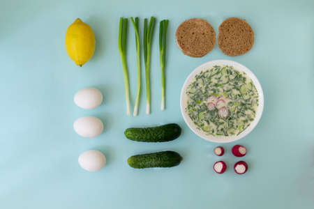 Cold soup in a deep white dish with ingredients. Okroshka, a traditional dish of Russian cuisine. Top view. Food knolling.の写真素材